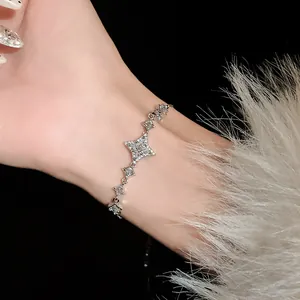 Elegant silver star bracelet with pavé zircons worn on wrist with luxury fur detail
