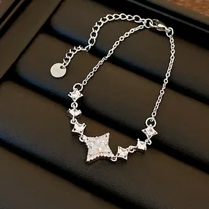 Detailed macro view of silver star pendant necklace with sparkling cubic zirconia stones