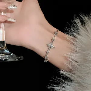 Detail view of a silver star and zircon bracelet with sparkling stones on wrist