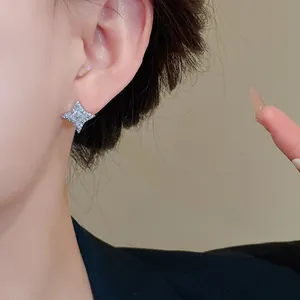 Close-up detail of a sparkling silver star-shaped stud earring with zircon inlay