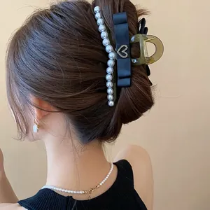 French style black hair claw clip with pearls and ribbon bow for elegant hair styling