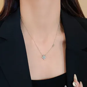 Elegant close-up of a silver-tone star pendant necklace with sparkling zircon on a model