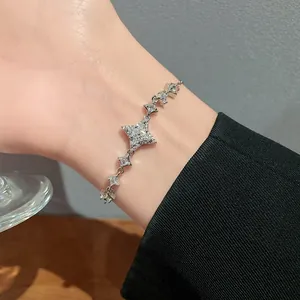 Close-up view of a sparkling star pendant bracelet featuring shiny zirconia on a wrist