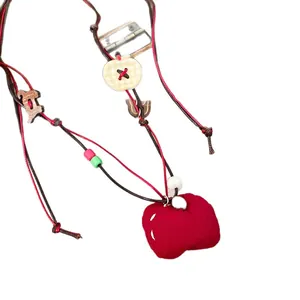 Handmade fabric beaded necklace with red heart pendant and wooden charm accessories.