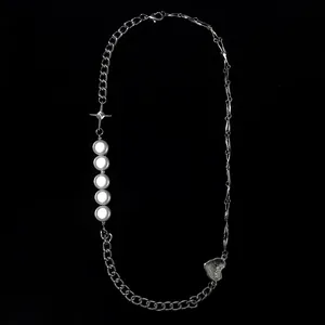 Asymmetric silver chain necklace with pearls, star, and heart charms on black background.