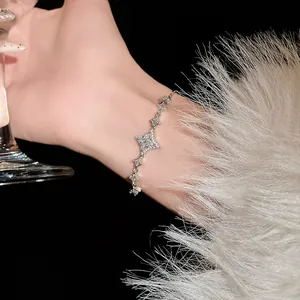 Close-up of elegant silver bracelet with sparkling star-shaped zircons on a lady's wrist