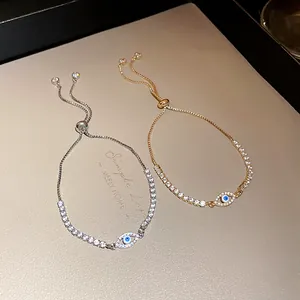 Close-up of adjustable evil eye bracelets with sparkling zircon stones in gold and silver