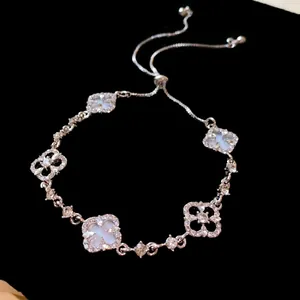Close-up of elegant hollow flower adjustable bracelet decorated with shimmering zircons