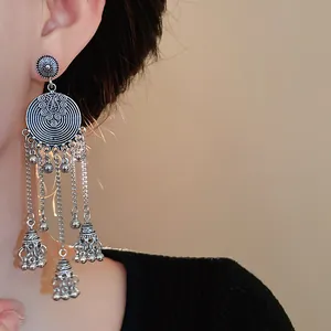 Detailed close-up of vintage silver bohemian tassel earrings with elegant dangling bell charms