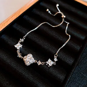Close-up of sparkling zircon clover bracelet with adjustable bolo clasp design