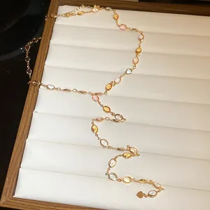 Detailed view of elegant gold-toned necklace with colorful resin oval gems.