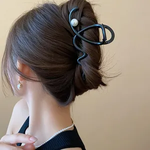 Back view of elegant French style black hair shark clip with pearl decoration.