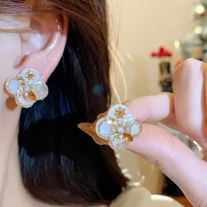 Elegant 18K gold plated flower stud earrings featuring white pearls and zircons