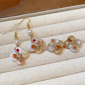Close-up of retro 18K gold-plated flower earrings with pearls and colorful zircons