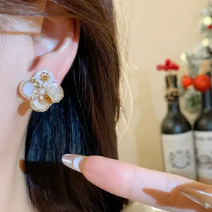 Close-up of 18K gold plated zircon flower pearl stud earrings with vintage palace style