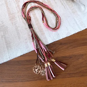 Bohemian multi-strand necklace with pink acrylic beads, brown fringe tassels and heart pendant