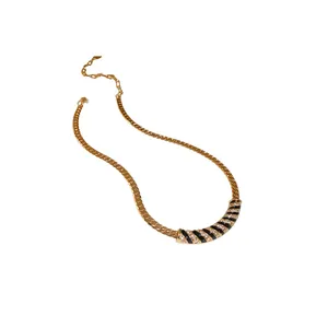 Elegant vintage gold plated necklace featuring black enamel and sparkling rhinestones