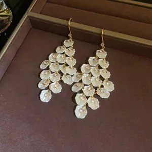 Detailed view of elegant shell petal tassel earrings with sparkling zircon stones