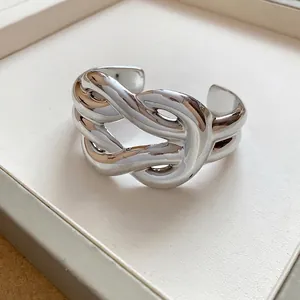 Chunky silver wavy open cuff bracelet with polished finish and bold geometric design