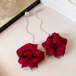 Elegant long drop earrings with red fabric roses and faux pearls.