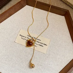 Vintage gold heart-shaped resin pendant necklace with adjustable long sweater chain