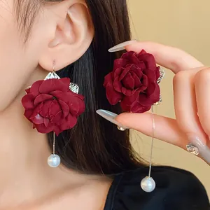 Long drop earrings with dark red fabric roses and elegant faux pearls on silver chains.