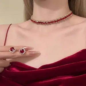 Detailed macro view of vintage red gemstone choker necklace and matching stud earrings set