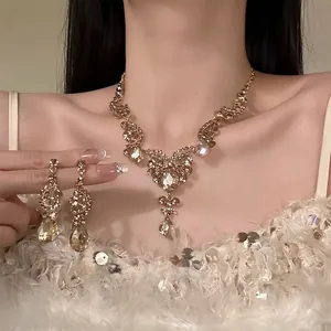 Close-up detail of luxury vintage golden necklace and crystal teardrop earrings set