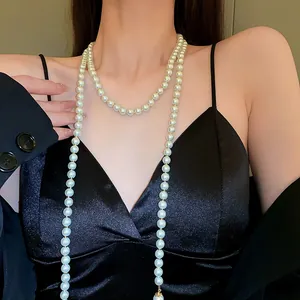 Elegant long multi-layer cream pearl necklace in French vintage style worn on a black dress
