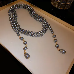 Elegant French retro multi-layer long necklace with dark grey pearls on display tray.