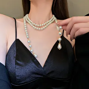 Close-up of elegant French retro multi-layer pearl necklace with a drop pendant