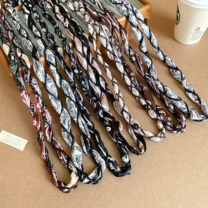 Variety of braided silk scarf waist chains with paisley patterns and beads