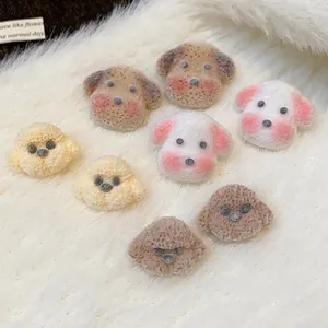 Close-up view of cute plush puppy-shaped stud earrings on soft white fur background