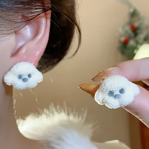 Close-up of cute white puppy stud earrings with a fluffy texture for women.