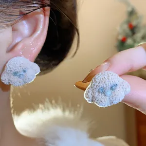 Close-up of cute fuzzy poodle dog earrings with silver needle detail and soft resin texture.