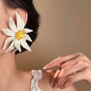 Macro close-up detail of an oversized white 3D flower earring worn by an Asian model