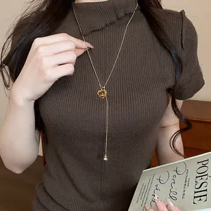 Vintage heart-shaped resin pendant necklace in Maillard brown, adjustable sweater chain detail