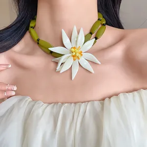 Exaggerated 3D white flower choker with green beads for summer beach vacation style.