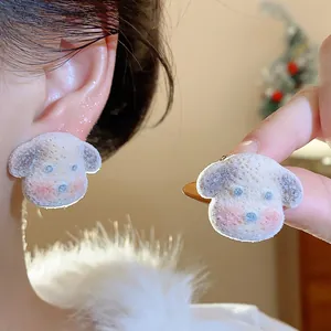 Close-up view of a cute flocked dog stud earring with silver needle shown on ear