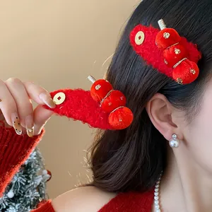 Detail of red flocked tanghulu hair clip worn by a woman for Chinese New Year.