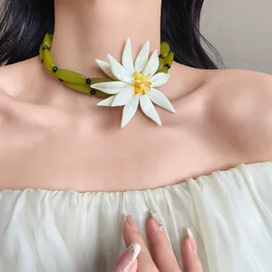 Detail showing a large 3D white flower choker necklace for a summer beach vacation style