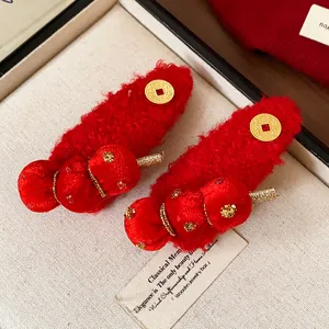 Close-up of New Year flocked tanghulu hair clips in festive red with golden accents.