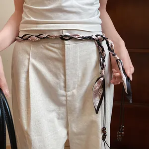 Close-up of bohemian silk scarf braided waist chain with elegant wooden bead charms