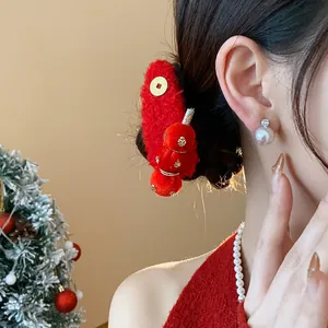 Detailed close-up of a festive red flocked tanghulu hair clip worn by a female model.