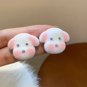 Detail view of cute white fuzzy puppy stud earrings featuring soft pink ears and cheeks