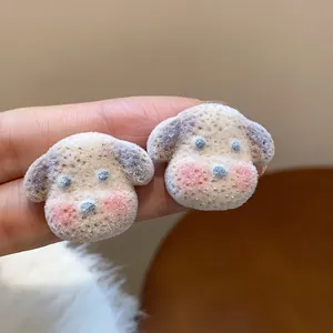 Close-up detail showing the soft flocking texture of cute puppy dog stud earrings.