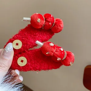 Detail view of festive red flocked hair clips featuring a traditional tanghulu design
