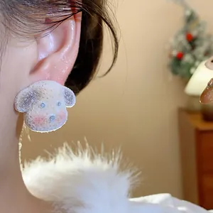 Close-up detail of cute flocked dog stud earrings with premium sterling silver needles