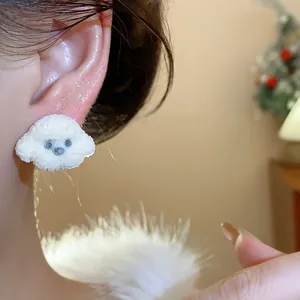 Detailed close-up view of a cute fluffy white poodle shaped stud earring worn on ear