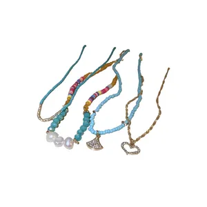 Set of four colorful beaded and pearl necklaces featuring heart and fan charm pendants